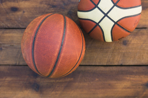 an-overhead-view-of-two-basketball-on-wooden-textured-background_23-2147924654.jpg