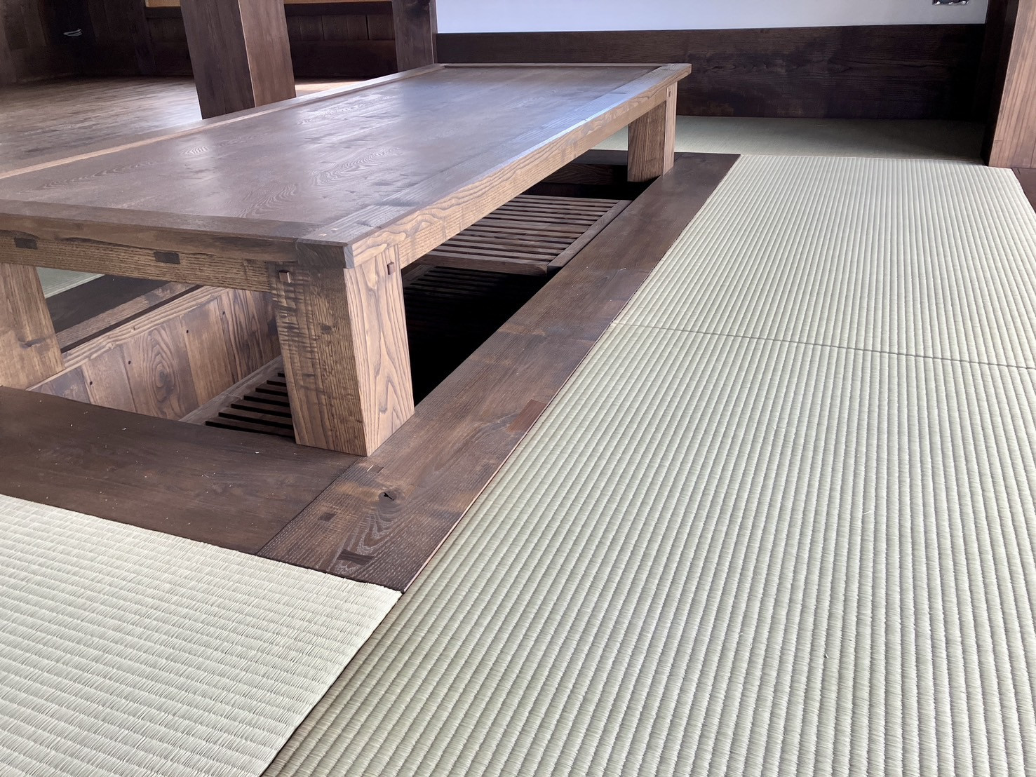 【施工後】別角度から見た無垢床の段差と天然い草の引目の細やかな織り目が完璧に調和している極上の和室空間写真｜佐藤畳工業